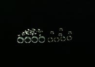 FIGURE 1. Molded optics can start with raw materials made of plastic (left) or glass (right). Thermoplastic resins for plastic optical injection molding are provided in extruded and cut pellet form. The PGM process requires a precision preform prior to molding.