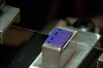 A passive chip from one of the AIM Photonics PIC Kits being optically characterized at Bridgewater State University in Massachusetts.